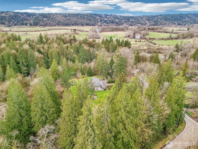 birds eye view of property featuring a forest view