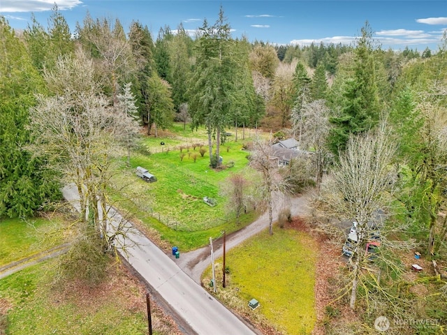 drone / aerial view with a wooded view