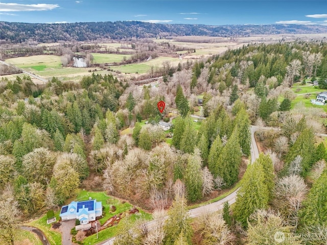 birds eye view of property with a forest view