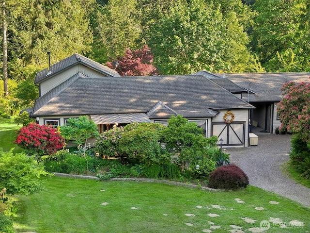 26821 NE 124th St, Duvall, WA 98019 - view of side of home with a yard, gravel driveway, and a garage