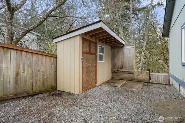 view of shed with fence