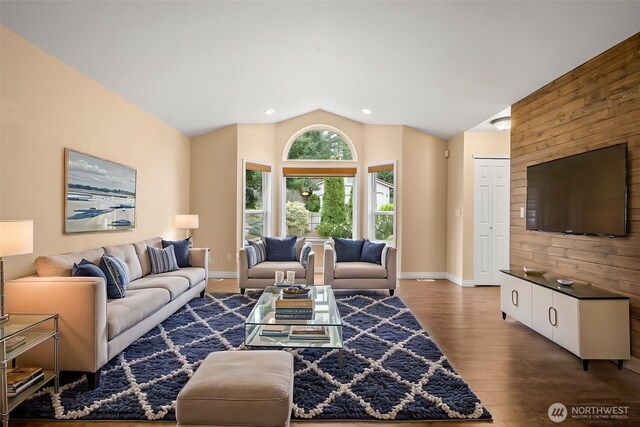 living room with recessed lighting, wood finished floors, baseboards, and vaulted ceiling