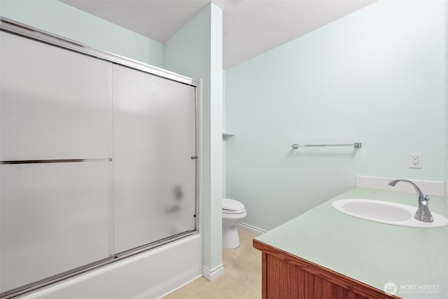 full bathroom featuring a sink, enclosed tub / shower combo, and toilet