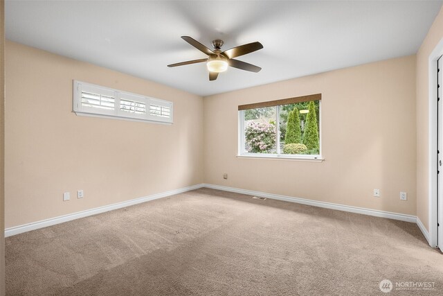 unfurnished room featuring visible vents, ceiling fan, baseboards, and carpet