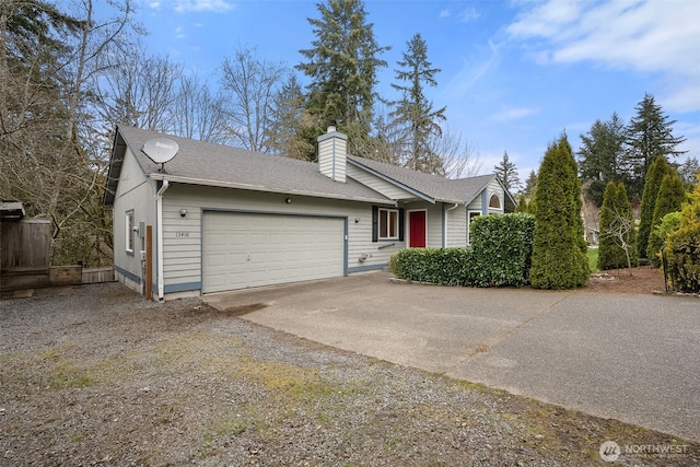 view of front of house featuring an attached garage, a chimney, driveway, and roof with shingles