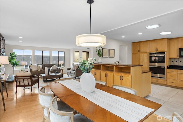 dining area with recessed lighting and light wood finished floors