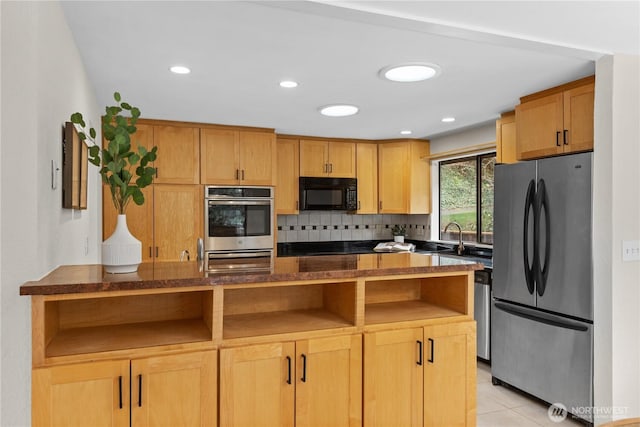 kitchen featuring tasteful backsplash, light tile patterned floors, recessed lighting, stainless steel appliances, and a sink