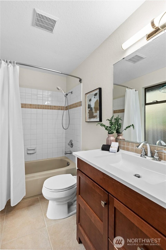 full bath with tile patterned floors, visible vents, a textured ceiling, shower / bath combination with curtain, and vanity