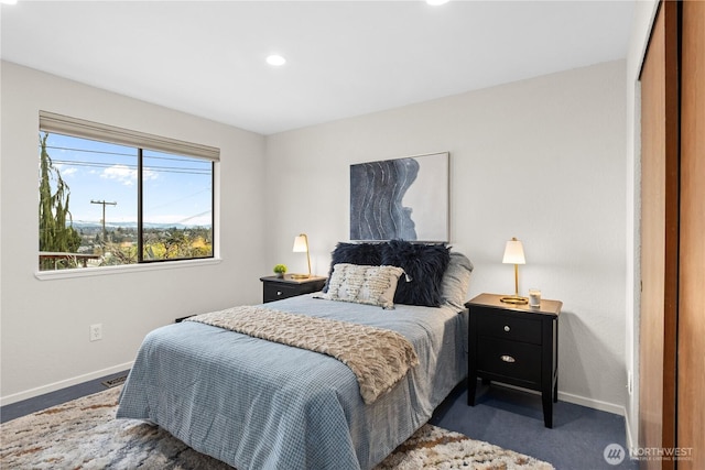 carpeted bedroom featuring visible vents and baseboards