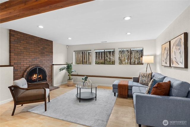 living area featuring wood finished floors, recessed lighting, a fireplace, and baseboards