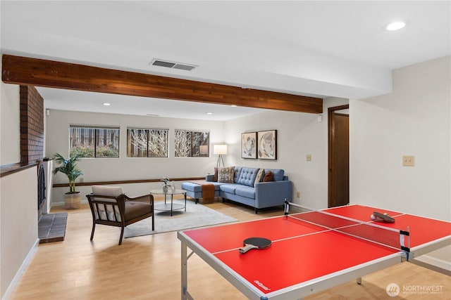 game room featuring beam ceiling, recessed lighting, visible vents, and light wood-type flooring