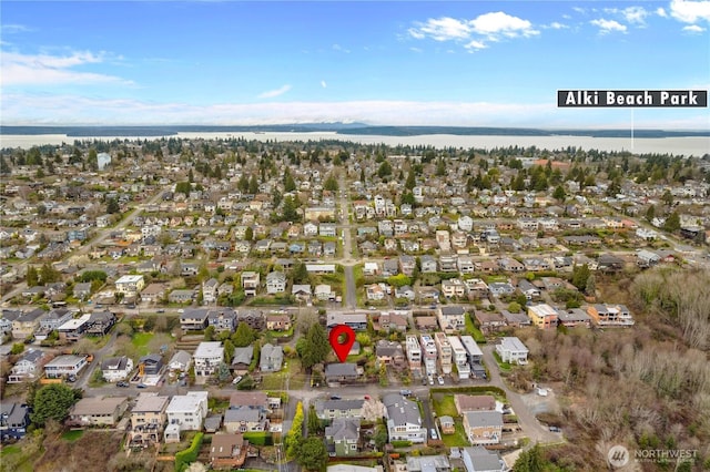 drone / aerial view with a residential view and a water view