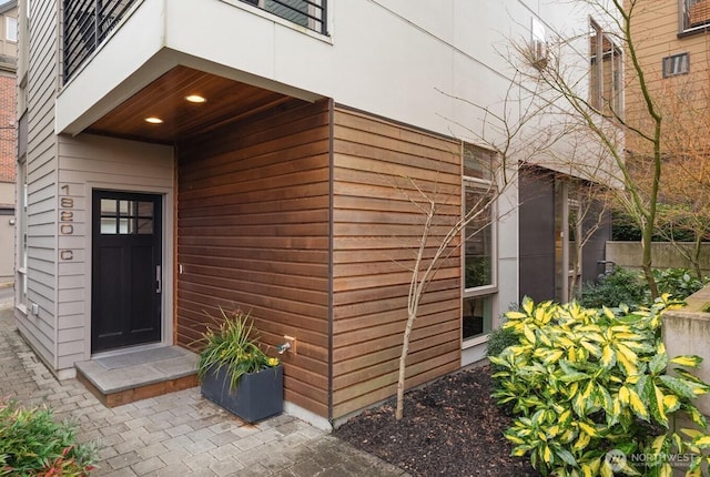 doorway to property featuring fence