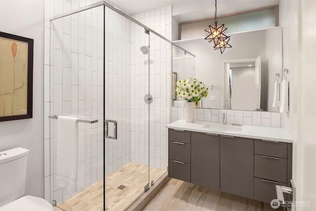 full bathroom with decorative backsplash, a shower stall, toilet, and vanity