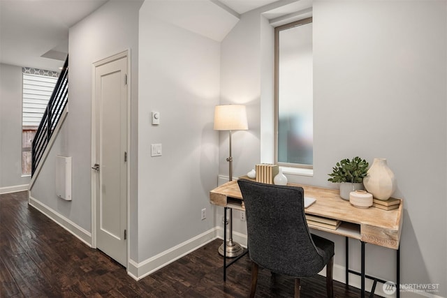 office space with baseboards and wood finished floors