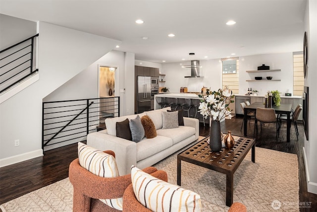 living room featuring recessed lighting, baseboards, and wood finished floors