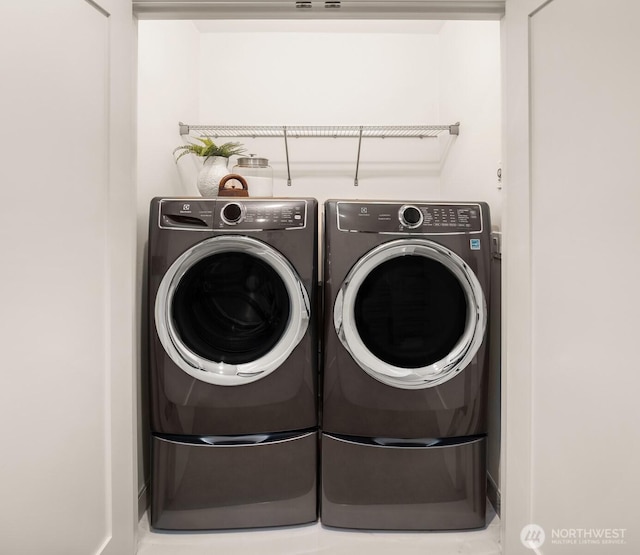 washroom featuring washer and dryer and laundry area