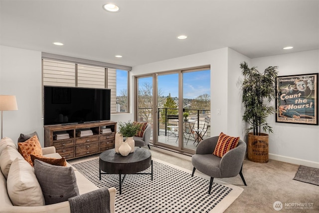 living room featuring recessed lighting, light colored carpet, and baseboards