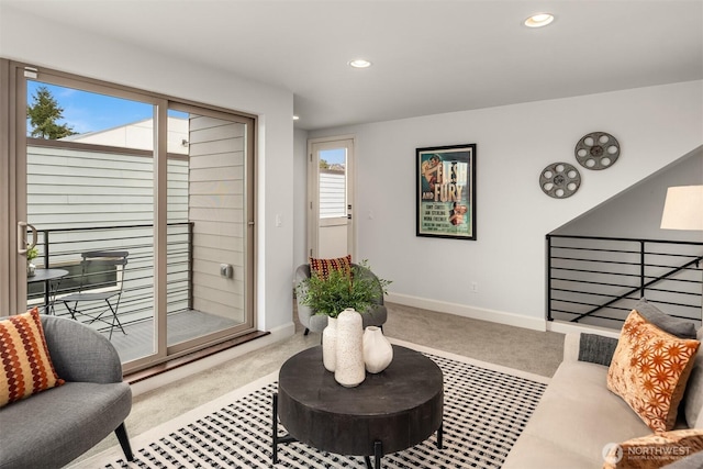 carpeted living area with recessed lighting and baseboards