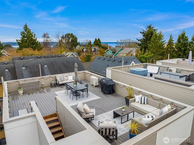 exterior space with outdoor dining space, an outdoor living space, a jacuzzi, and grilling area