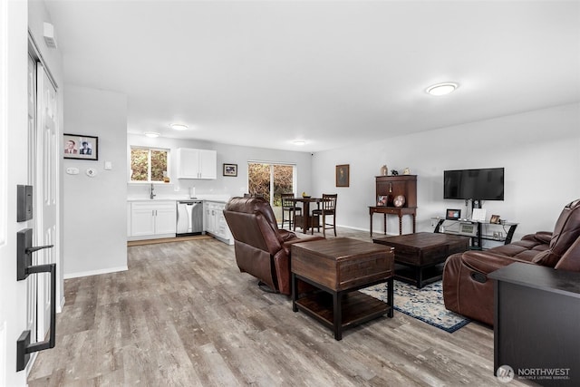 living room featuring light wood-type flooring and baseboards