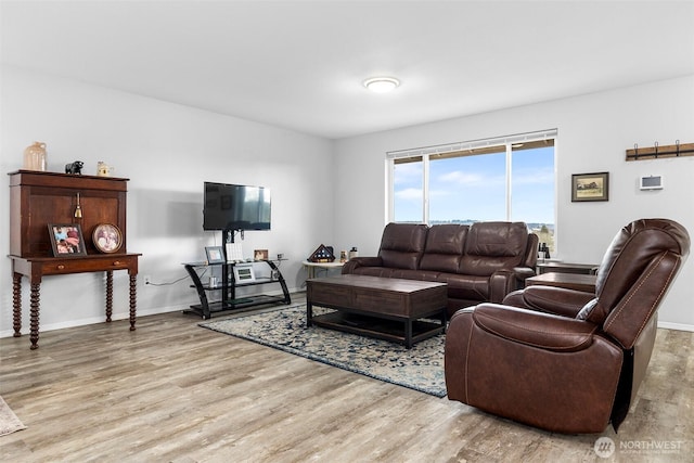 living room with light wood finished floors and baseboards