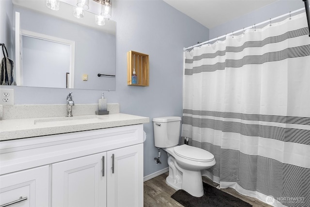 full bathroom with vanity, toilet, and wood finished floors