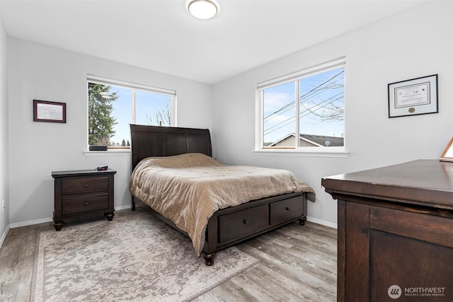 bedroom with baseboards and light wood-type flooring