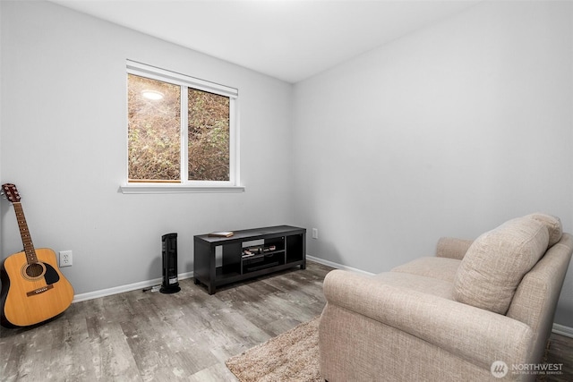 sitting room with wood finished floors and baseboards