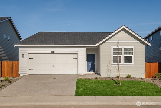 single story home featuring a shingled roof, an attached garage, concrete driveway, and fence