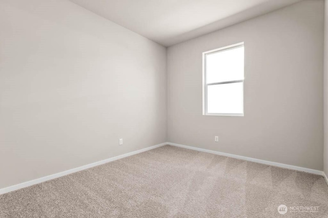 carpeted spare room with baseboards