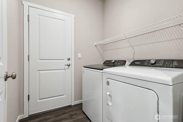 washroom featuring washer and dryer, baseboards, dark wood-style flooring, and laundry area