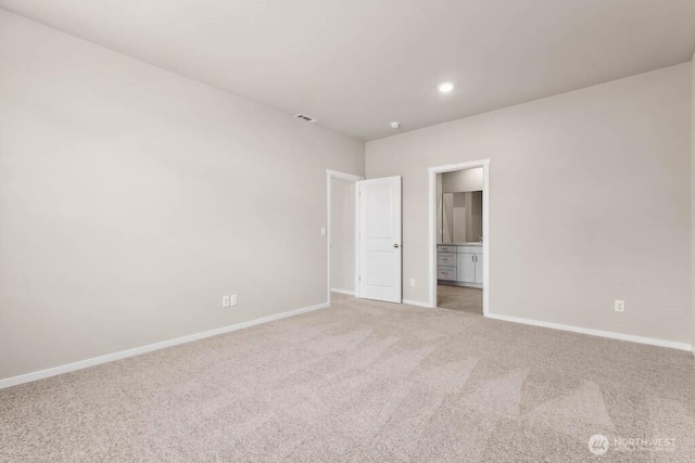 unfurnished bedroom featuring visible vents, connected bathroom, baseboards, light carpet, and recessed lighting