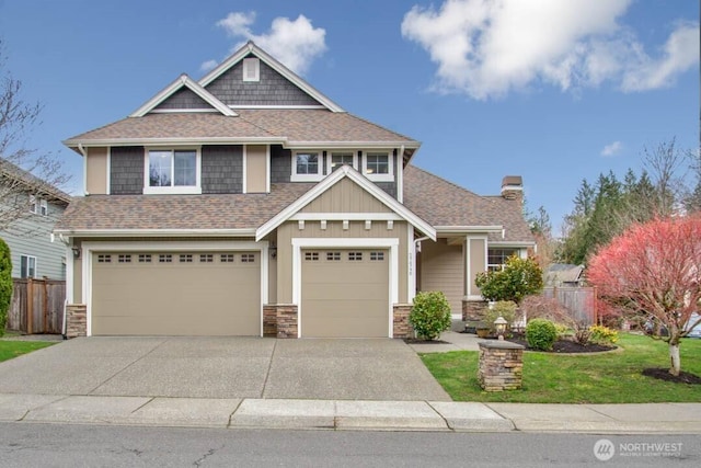 craftsman inspired home with an attached garage, a shingled roof, driveway, and fence