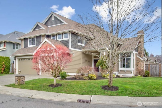 view of front of home featuring fence, concrete driveway, an attached garage, a shingled roof, and a front yard