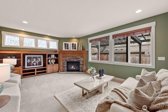 living area with recessed lighting, carpet, and a fireplace