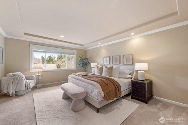 carpeted bedroom with a raised ceiling, recessed lighting, baseboards, and ornamental molding