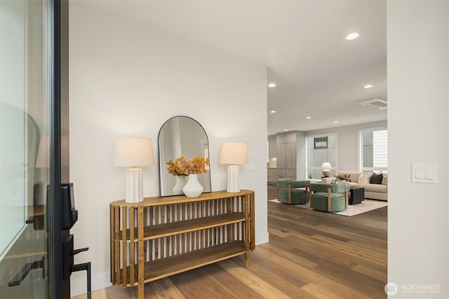 hall with visible vents, recessed lighting, and wood finished floors