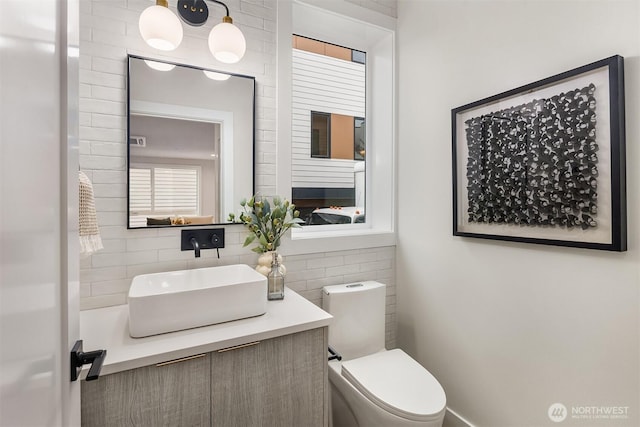 half bath featuring toilet and vanity