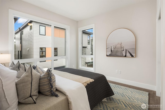 bedroom with baseboards and carpet floors