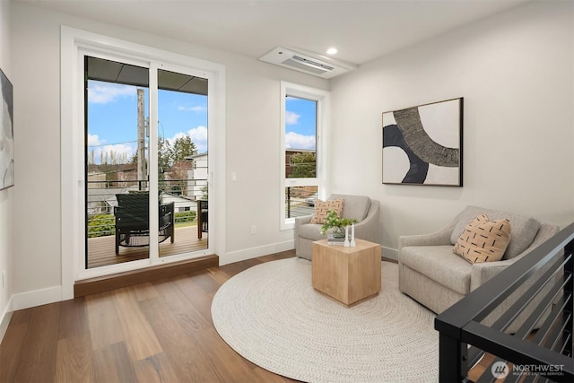 living area with visible vents, recessed lighting, baseboards, and wood finished floors