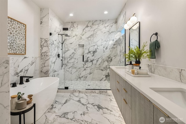 full bath with a marble finish shower, double vanity, recessed lighting, a freestanding bath, and marble finish floor