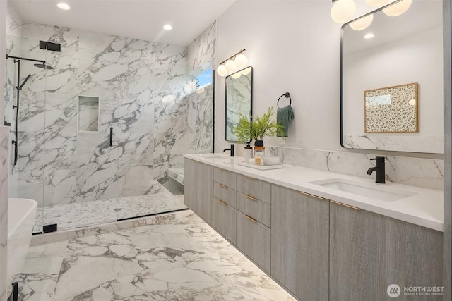 full bathroom featuring a sink, a marble finish shower, double vanity, and recessed lighting