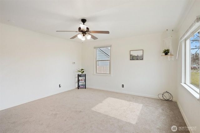 empty room with light carpet, ceiling fan, and baseboards