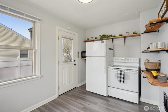 kitchen with open shelves, baseboards, white appliances, and wood finished floors