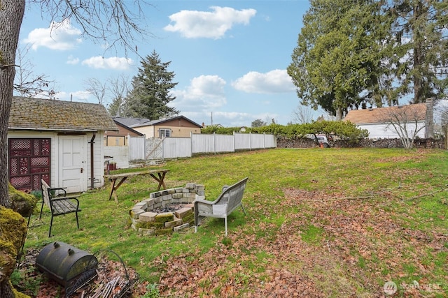 view of yard with fence and an outdoor fire pit