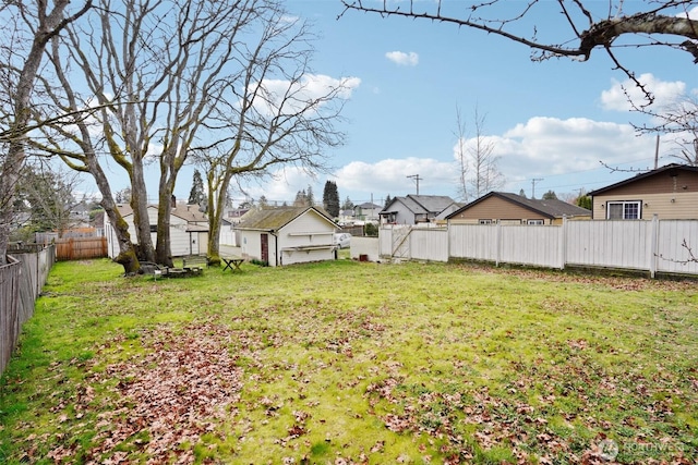 view of yard featuring a residential view and a fenced backyard