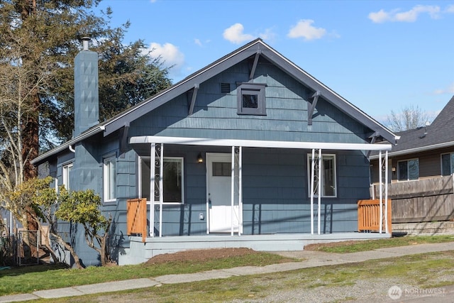 bungalow with a porch and a chimney