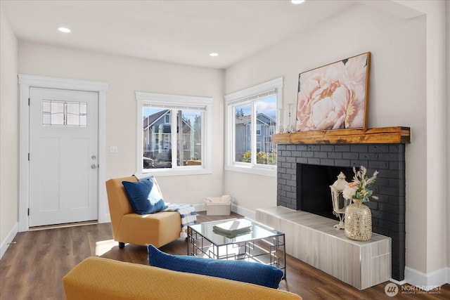 living area featuring recessed lighting, a fireplace, baseboards, and wood finished floors