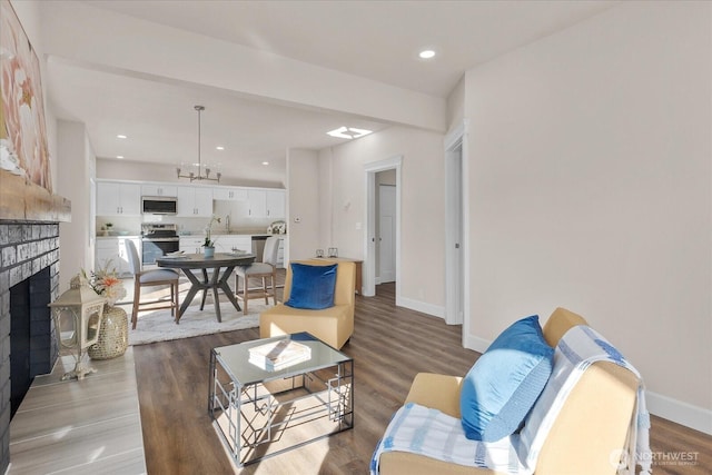 living room with visible vents, baseboards, recessed lighting, light wood-style flooring, and a fireplace